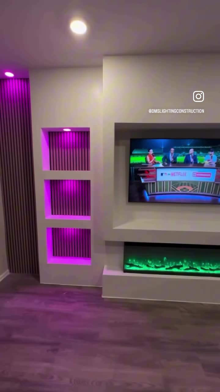 Close view of backlit display niches glowing magenta beside a slat accent panel